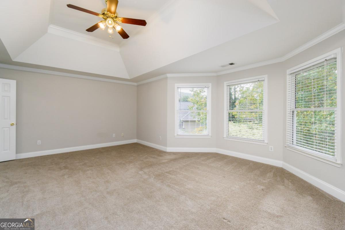6710 Timber Cove Pointe Cumming, GA 30041 - Photo 26 of 51 an empty room with windows and fan