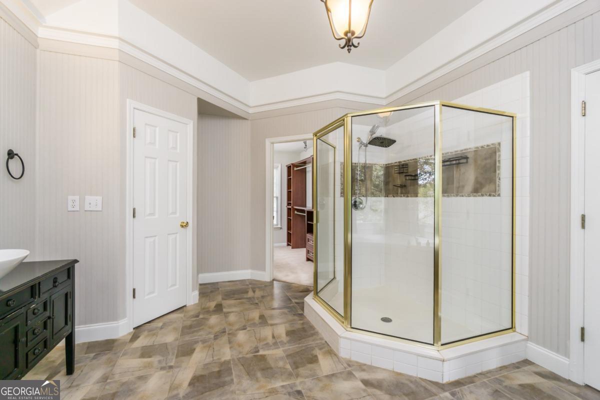 6710 Timber Cove Pointe Cumming, GA 30041 - Photo 28 of 51 a view of a bathroom with a glass shower door
