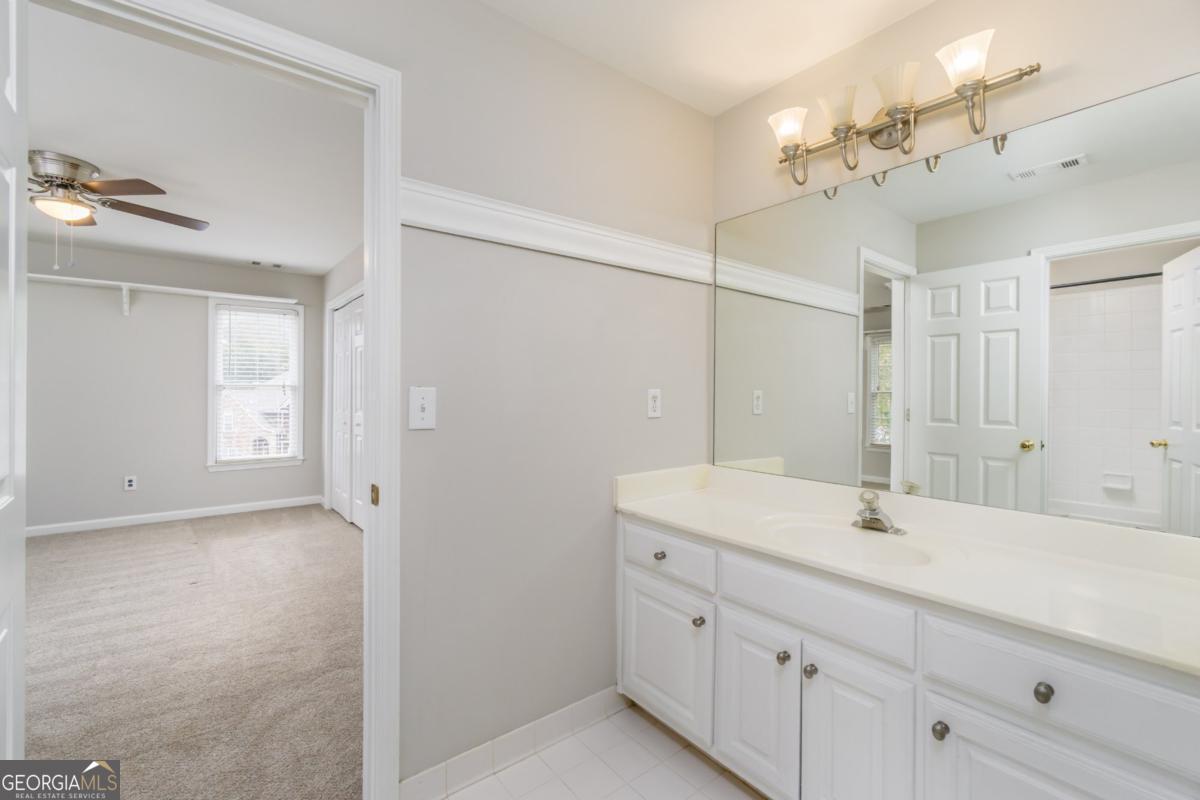 6710 Timber Cove Pointe Cumming, GA 30041 - Photo 32 of 51 a bathroom with a sink a vanity and a mirror