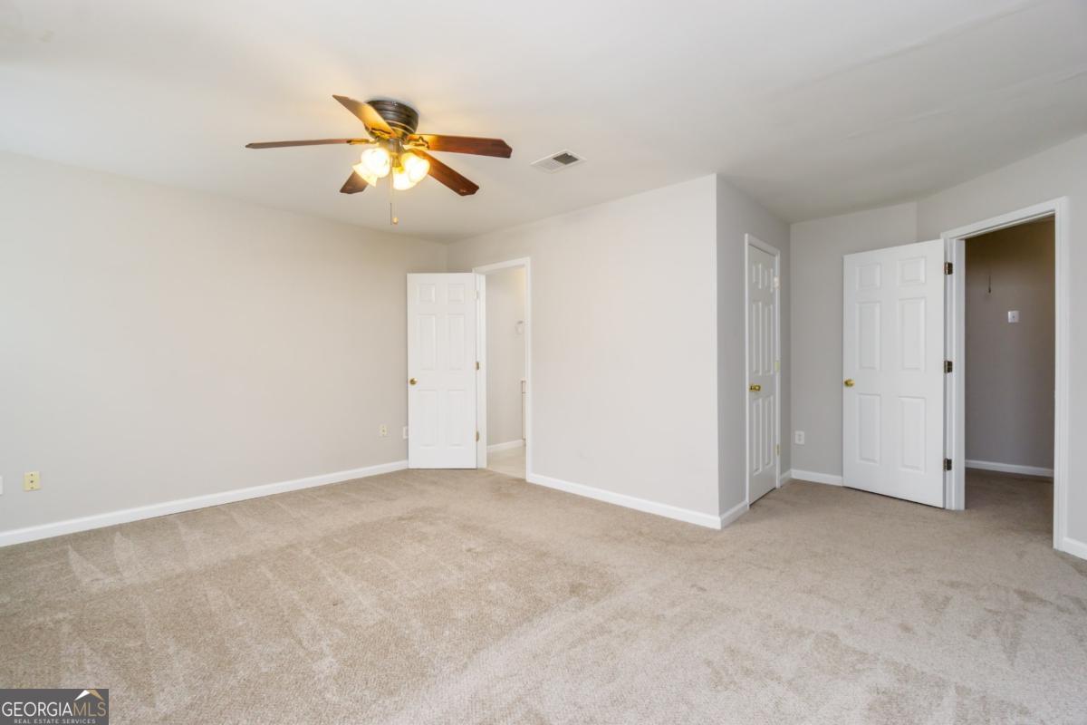 6710 Timber Cove Pointe Cumming, GA 30041 - Photo 36 of 51 a view of an empty room with a ceiling fan