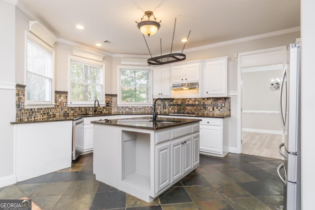 6710 Timber Cove Pointe Cumming, GA 30041 - Photo 6 of 51 a kitchen with stainless steel appliances granite countertop a sink stove and refrigerator