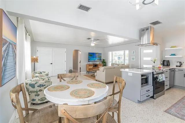 a large kitchen with a table and chairs
