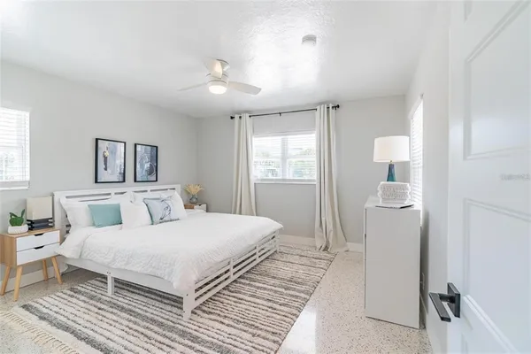 a bedroom with a large bed and a chandelier
