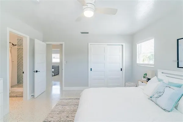 a bedroom with a bed and a chandelier
