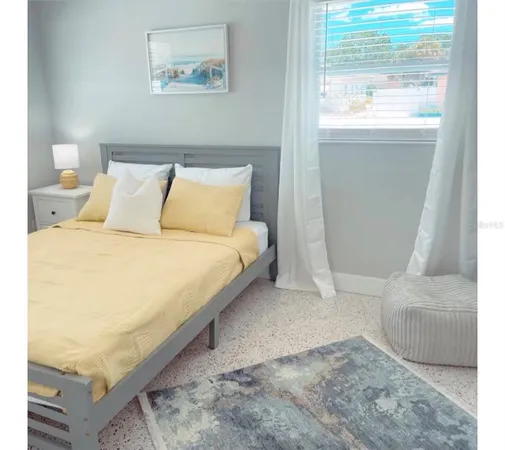 a bedroom with a bed and a window