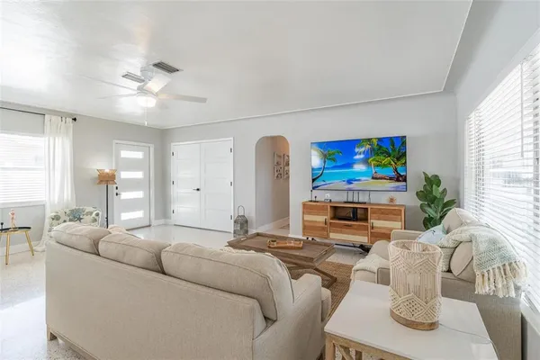 a living room with furniture and a flat screen tv