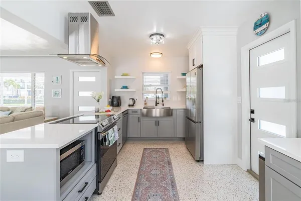 a large white kitchen with a large window