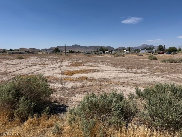 4580 Flamingo Road Pahrump, NV 89048 - Photo 3 of 3 A sprawling desert lot presents an open canvas for development, with distant mountains framing the horizon.