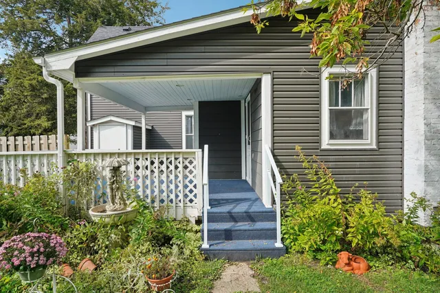 a front view of a house with a garden