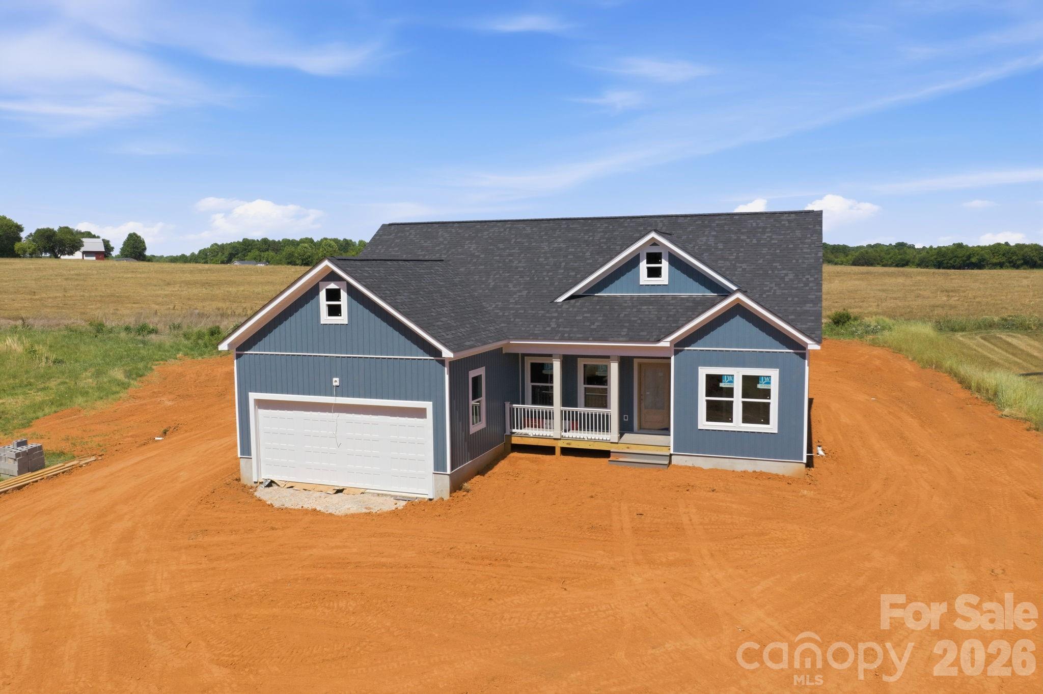 1720 Jennings Road Olin, NC 28660 - Photo 6 of 15 a front view of a house with a yard and garage
