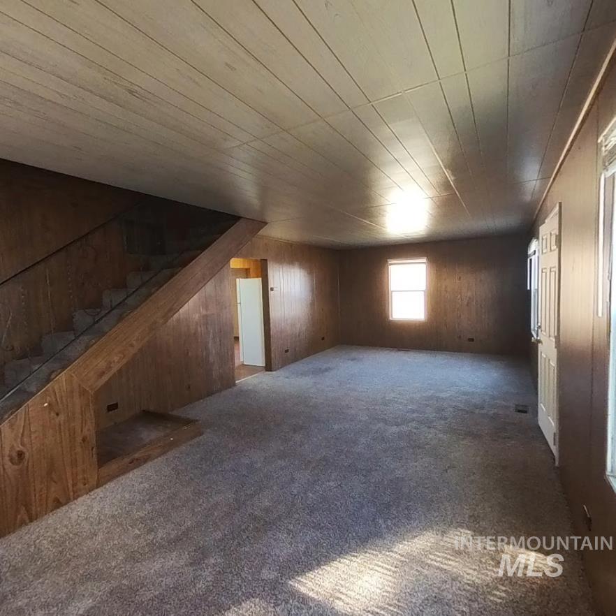 418 13th Street Clarkston, WA 99403 - Photo 17 of 26 Bonus room featuring carpet floors, wood walls, wood ceiling, and stairs