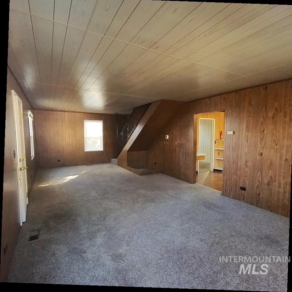 418 13th Street Clarkston, WA 99403 - Photo 18 of 26 Bonus room featuring carpet, wood walls, stairway, and wood ceiling