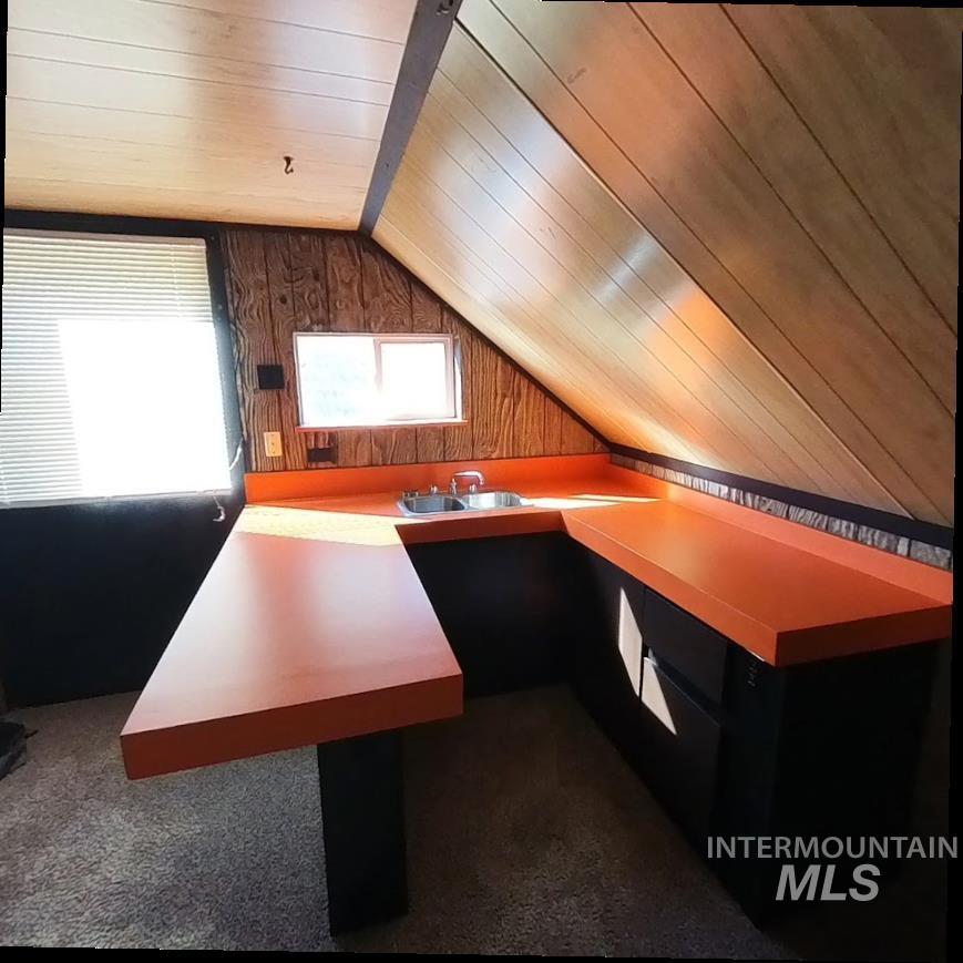 418 13th Street Clarkston, WA 99403 - Photo 10 of 26 Unfurnished office with wood walls, lofted ceiling, wooden ceiling, and dark colored carpet