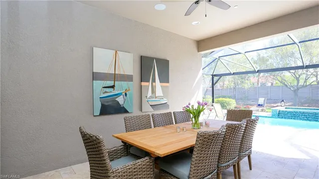 a view of a dining room with furniture a rug and wooden floor