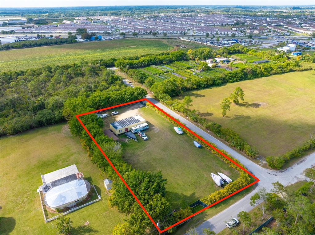 23600 Southwest 125th Avenue Homestead, FL 33032 - Photo 1 of 18 an aerial view of a residential houses with outdoor space swimming pool and ocean view