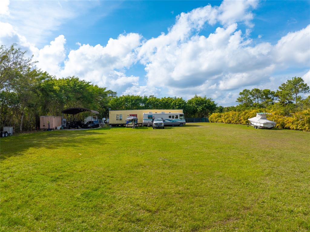 23600 Southwest 125th Avenue Homestead, FL 33032 - Photo 3 of 18 a front view of a house with a big yard