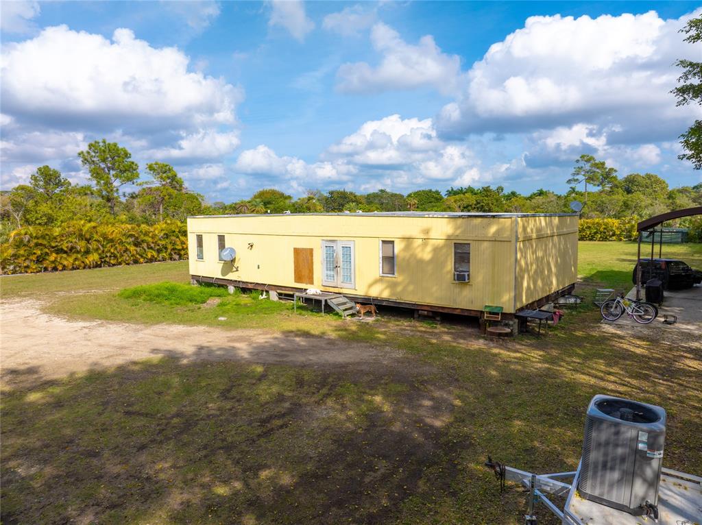 23600 Southwest 125th Avenue Homestead, FL 33032 - Photo 7 of 18 a view of a patio with table and chairs and potted plants