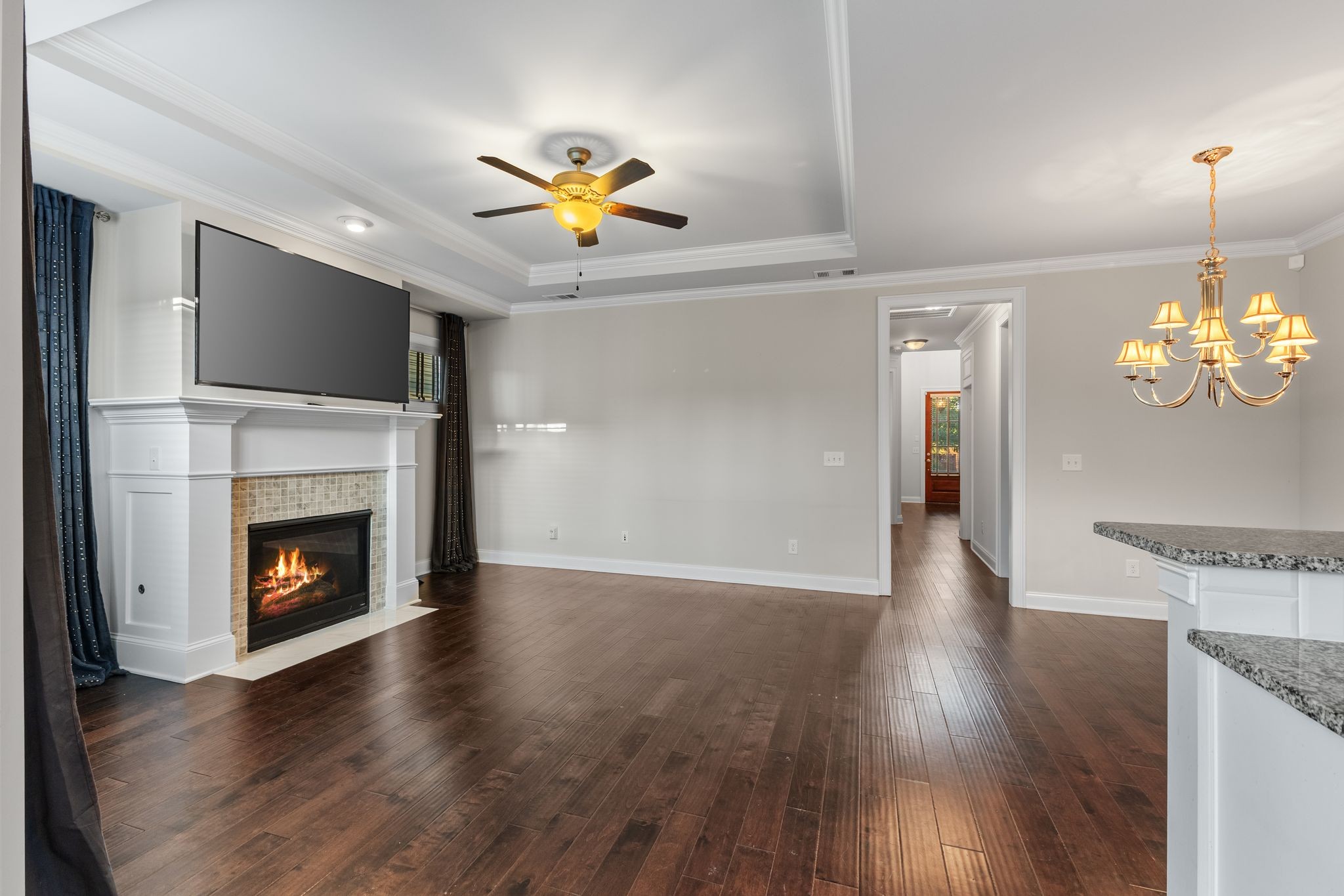 5102 Donovan Street Franklin, TN 37064 - Photo 12 of 45 a view of an empty room with a fireplace and wooden floor