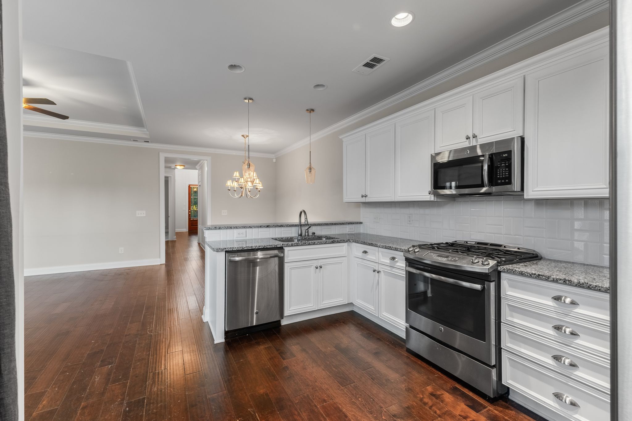 5102 Donovan Street Franklin, TN 37064 - Photo 17 of 45 a kitchen with stainless steel appliances granite countertop a stove and a microwave