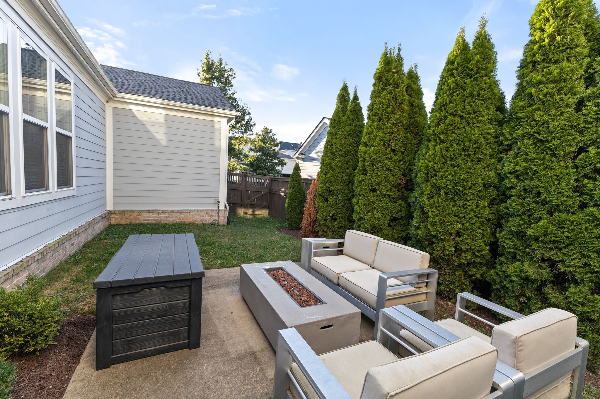 5102 Donovan Street Franklin, TN 37064 - Photo 38 of 45 a view of a patio with a dining table and chairs with a couches near a garden