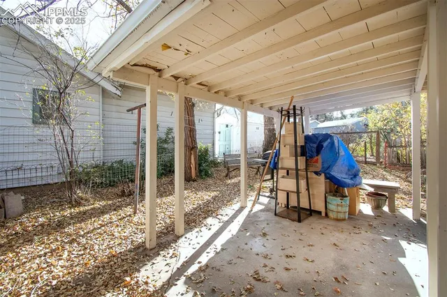 a view of a house with a yard and wooden fence