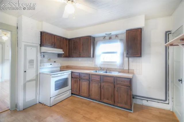 a kitchen with stainless steel appliances granite countertop a sink and a refrigerator