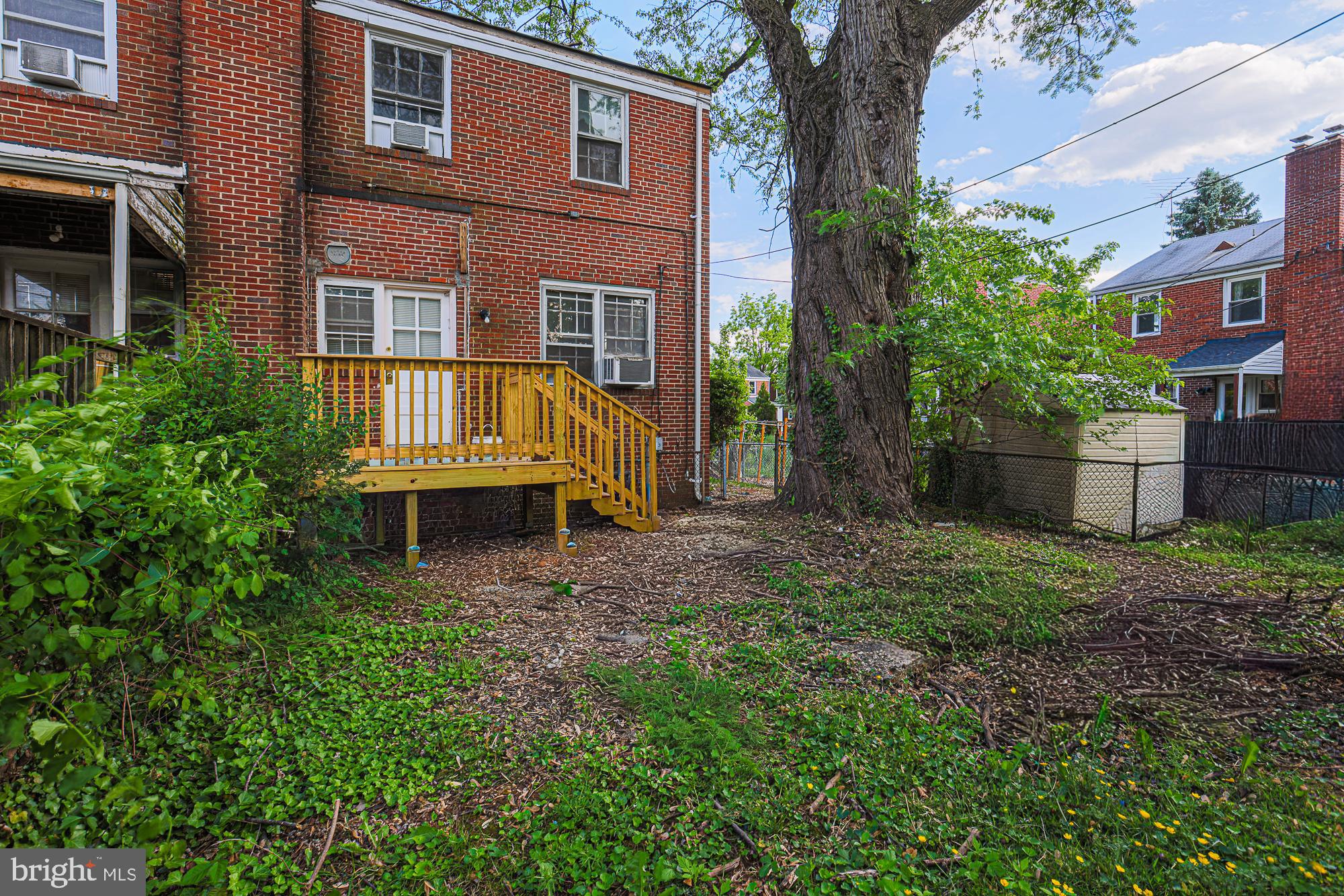 3914 Bancroft Road Baltimore, MD 21215 - Photo 18 of 25 front view of house with a yard and potted plants