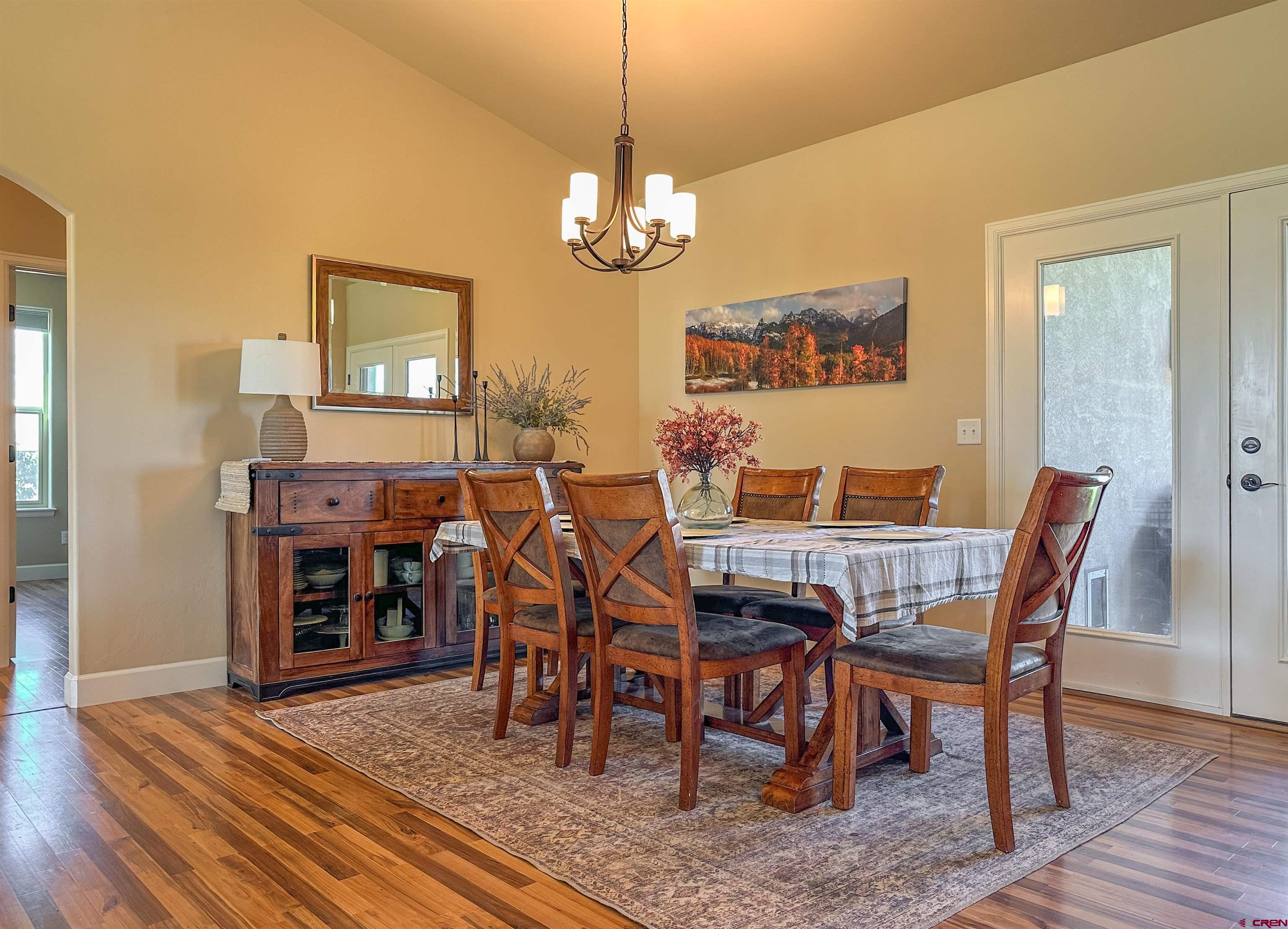 424 Shilo Court Delta, CO 81416 - Photo 12 of 45 a view of a dining room with furniture wooden floor and chandelier