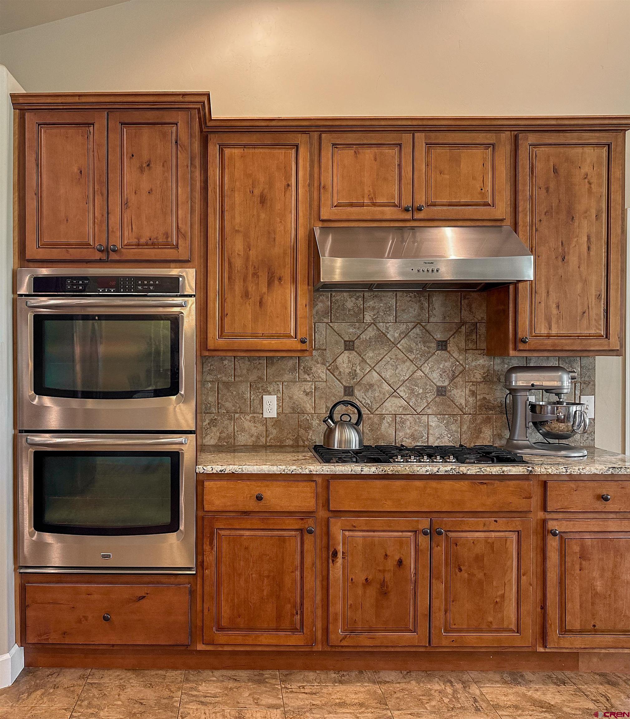 424 Shilo Court Delta, CO 81416 - Photo 16 of 45 a kitchen with granite countertop a stove and a microwave