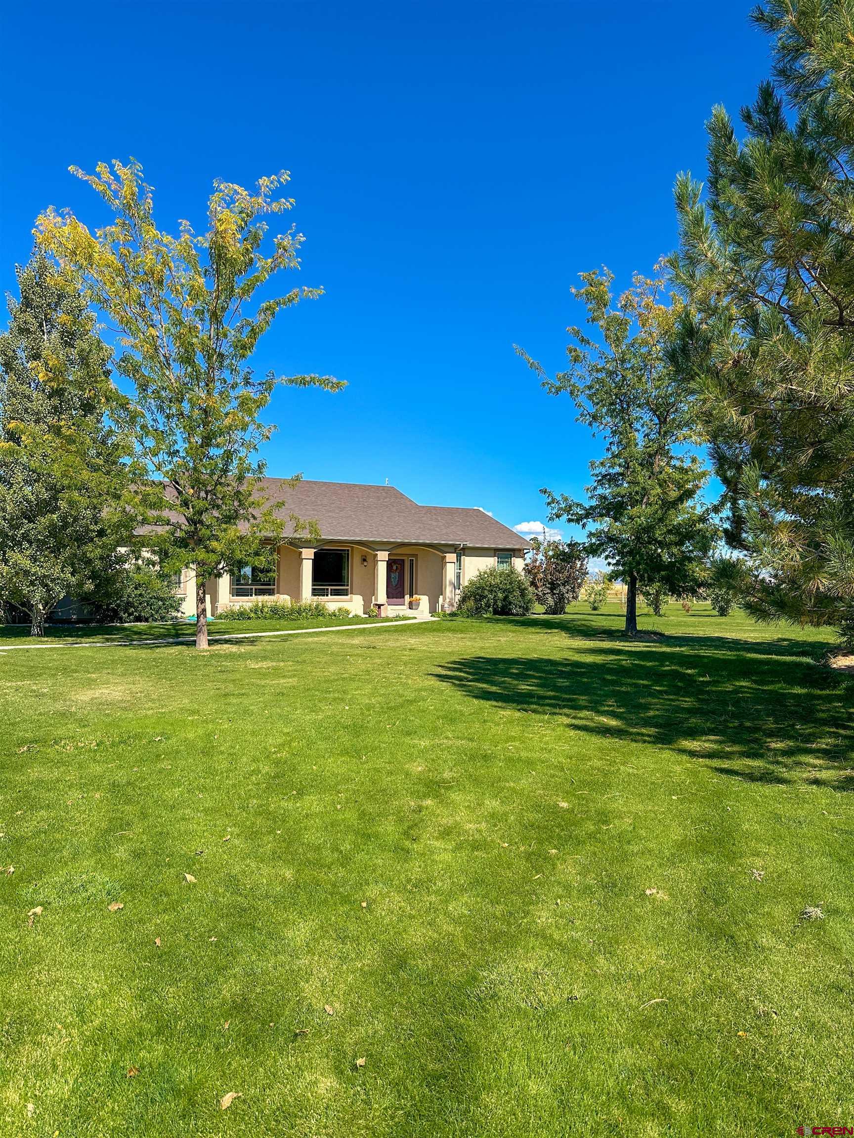 424 Shilo Court Delta, CO 81416 - Photo 2 of 45 a front view of a house with a garden