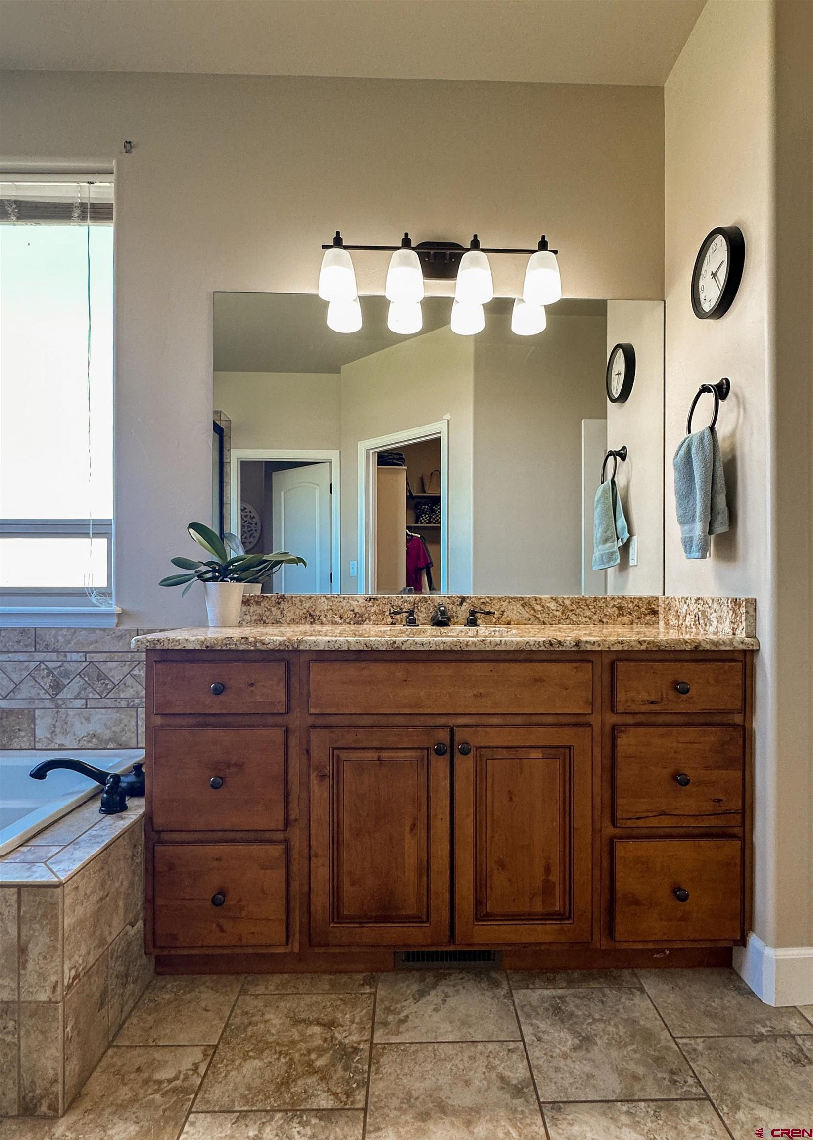 424 Shilo Court Delta, CO 81416 - Photo 22 of 45 a bathroom with a granite countertop double vanity sink and a mirror