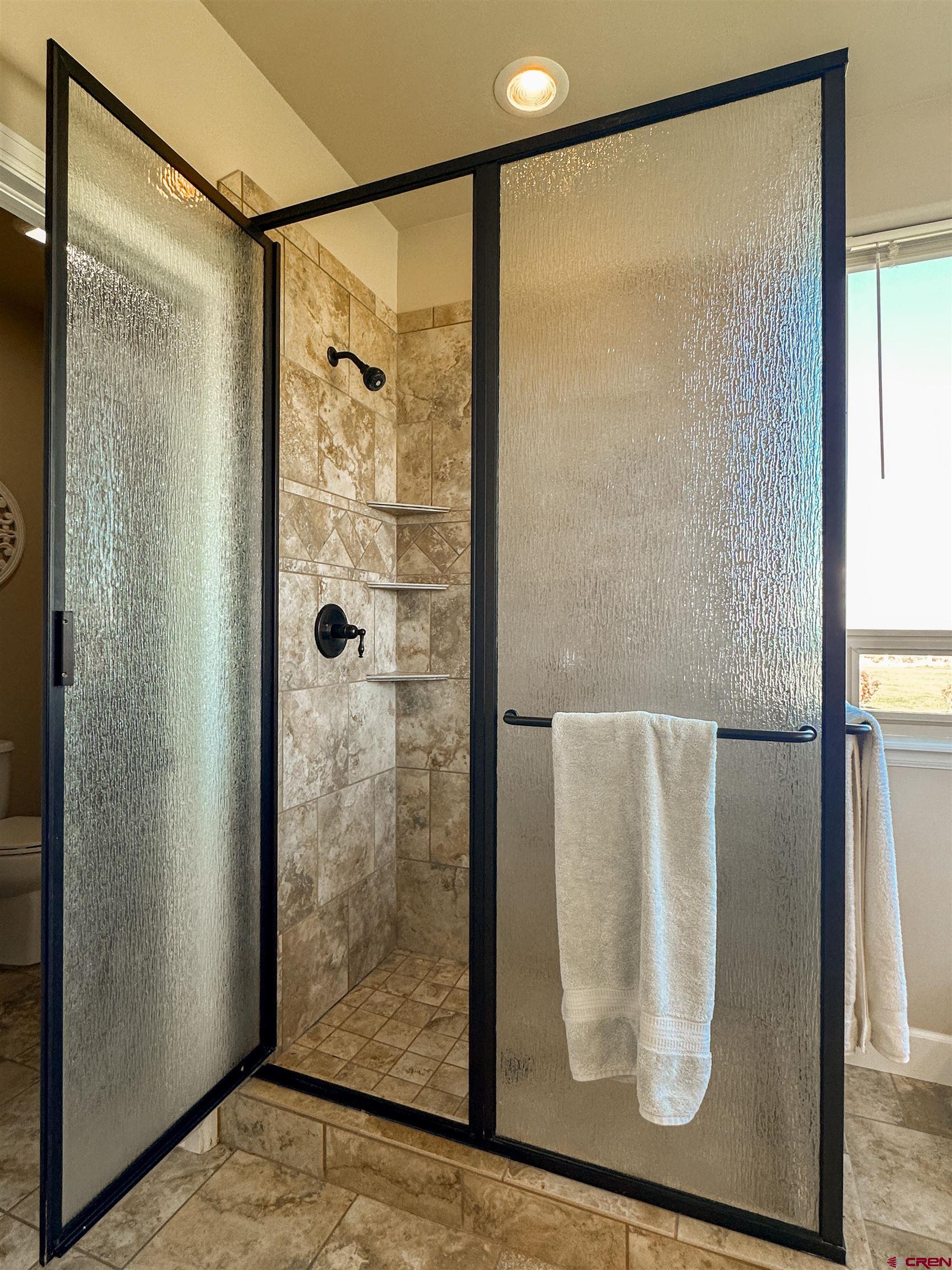424 Shilo Court Delta, CO 81416 - Photo 24 of 45 a bathroom with a glass shower door