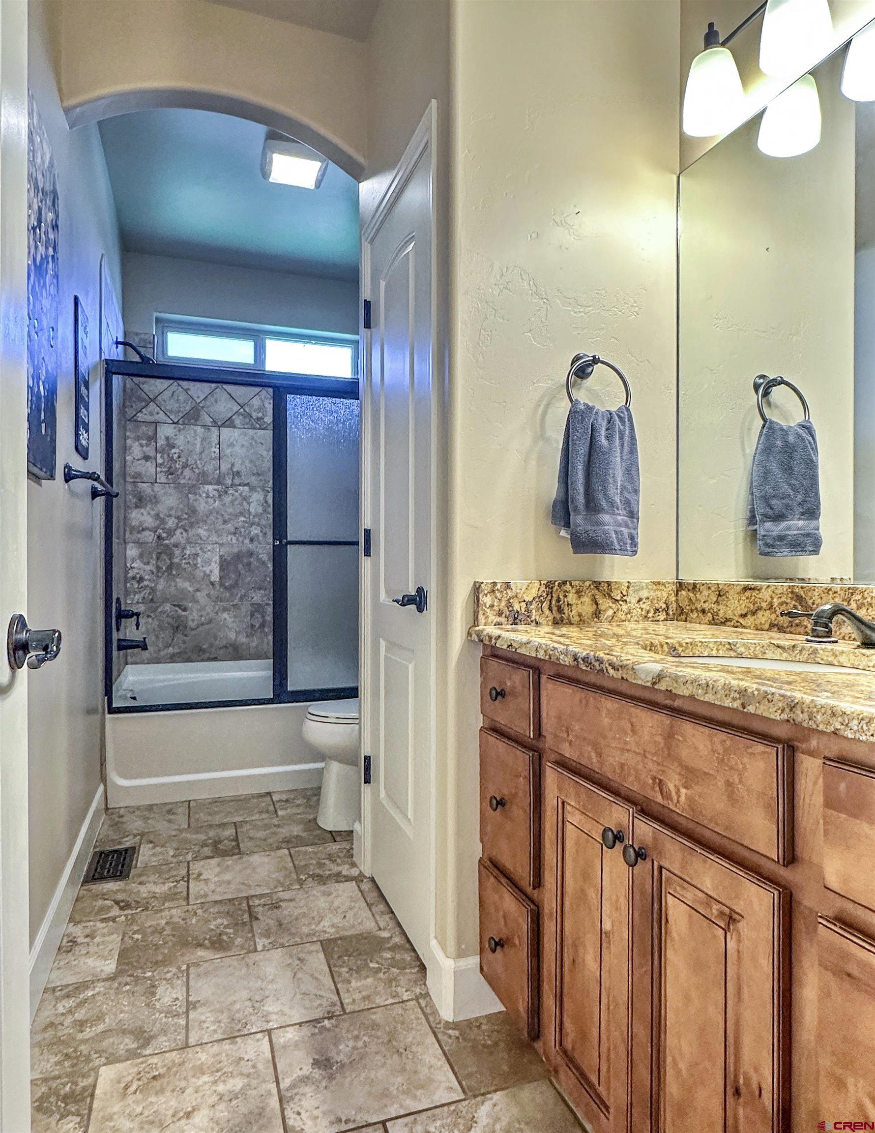 424 Shilo Court Delta, CO 81416 - Photo 28 of 45 a bathroom with a granite countertop sink and a mirror