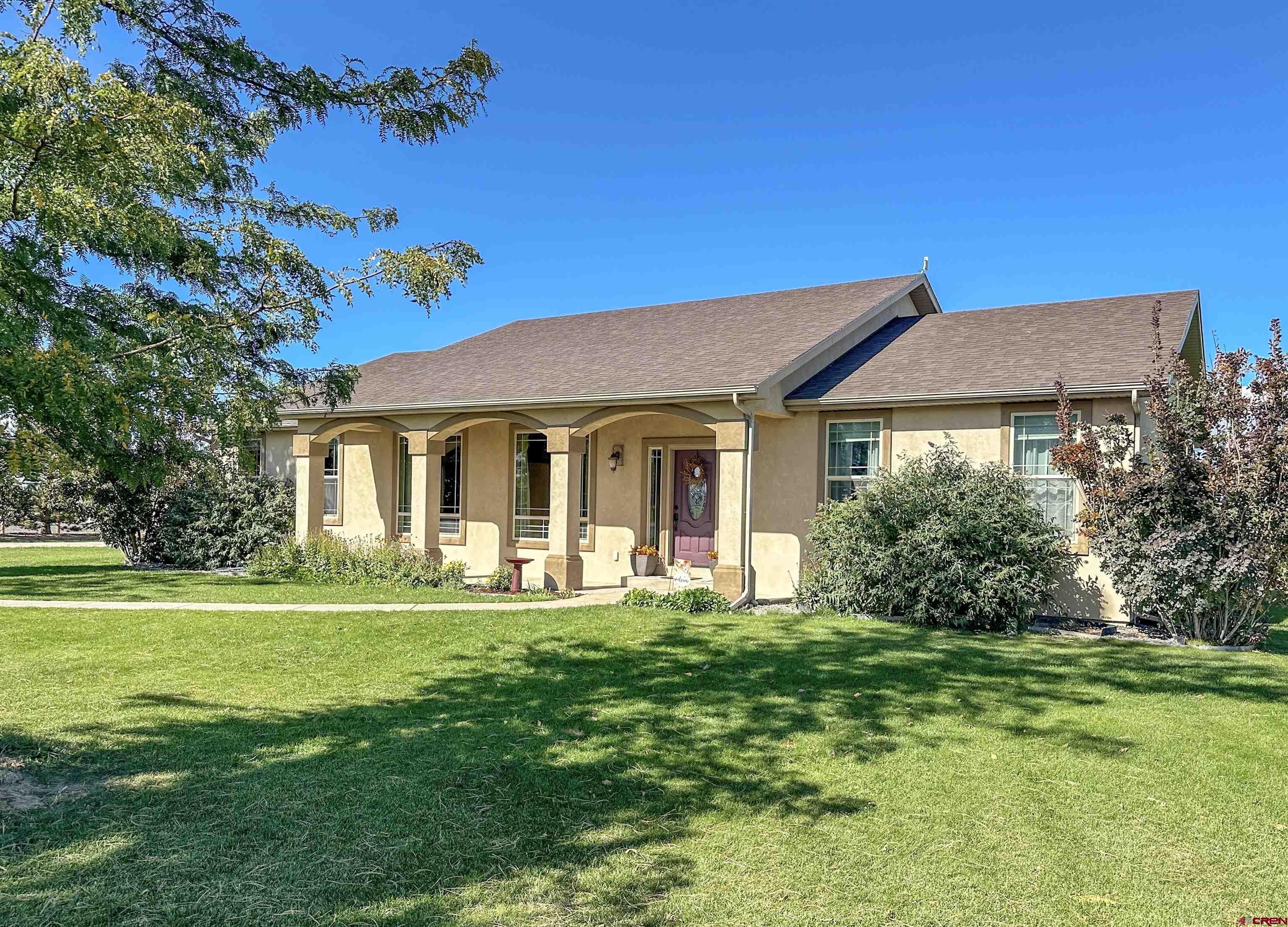 424 Shilo Court Delta, CO 81416 - Photo 3 of 45 a front view of a house with a yard table and chairs