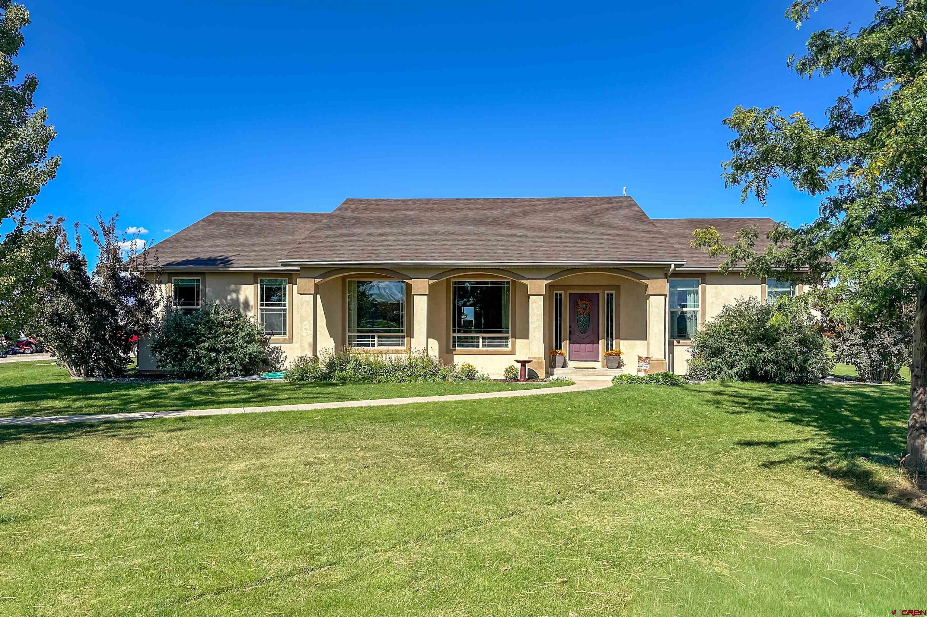 424 Shilo Court Delta, CO 81416 - Photo 41 of 45 a front view of a house with a garden