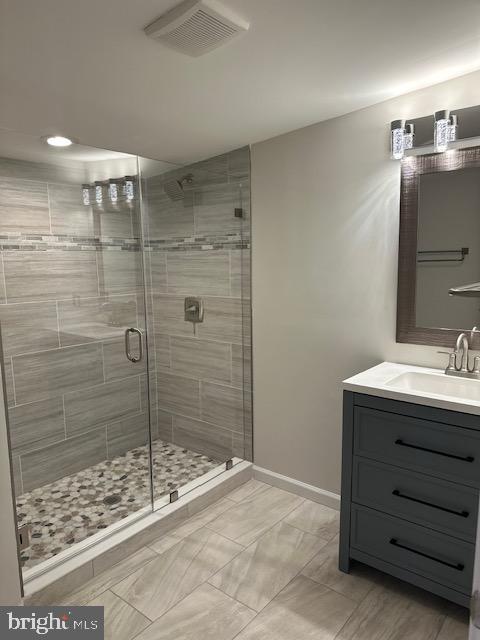 1004 South Cameron Street Winchester, VA 22601 - Photo 6 of 26 a bathroom with a granite countertop sink a mirror and shower