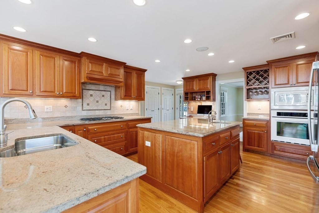 15 Gould Road Newton, MA 02468 - Photo 11 of 33 a kitchen with stainless steel appliances granite countertop a sink stove and refrigerator