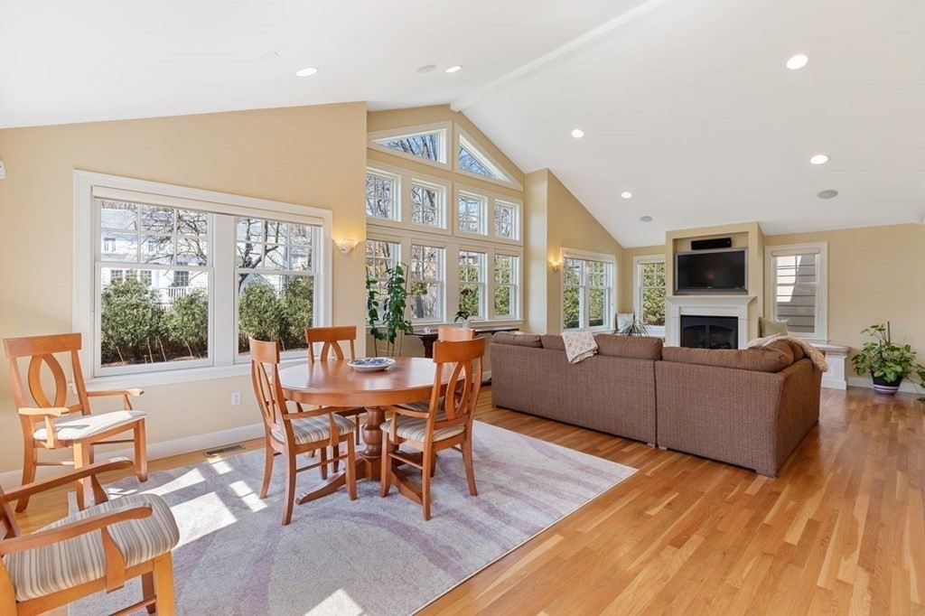 15 Gould Road Newton, MA 02468 - Photo 12 of 33 a dining room with furniture a fireplace and wooden floor