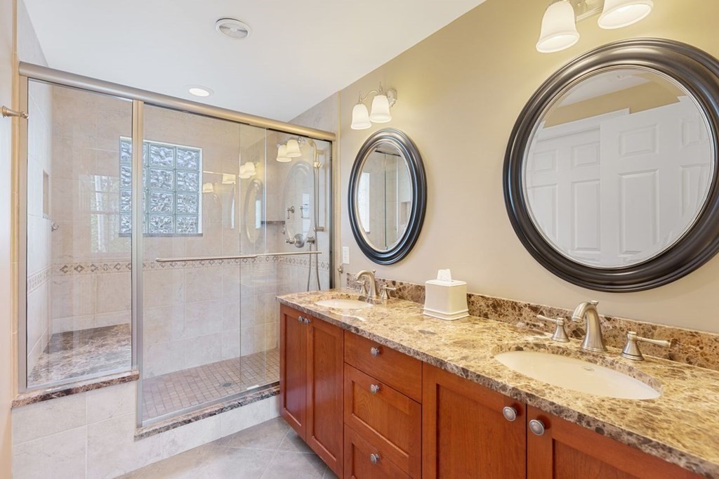 15 Gould Road Newton, MA 02468 - Photo 19 of 33 a bathroom with a granite countertop double vanity and a mirror