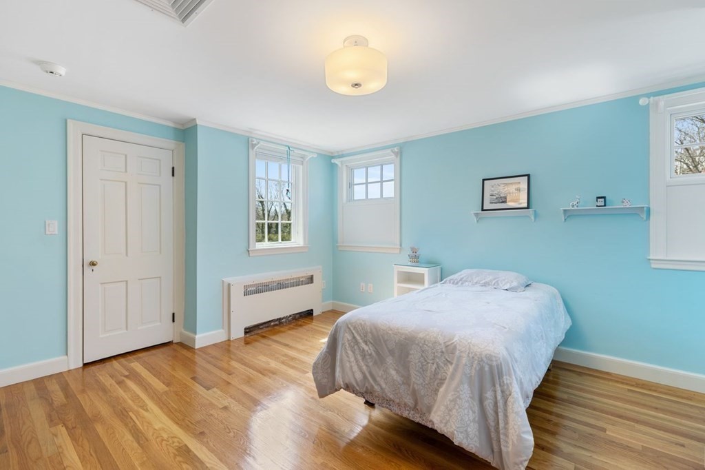 15 Gould Road Newton, MA 02468 - Photo 21 of 33 a bedroom with a bed and wooden floor