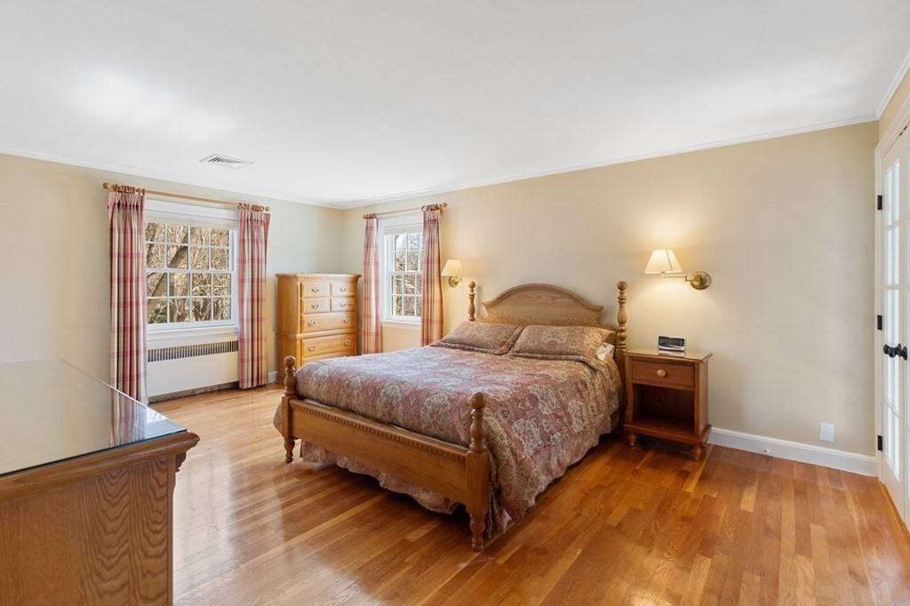 15 Gould Road Newton, MA 02468 - Photo 24 of 33 a bedroom with a bed and wooden floor