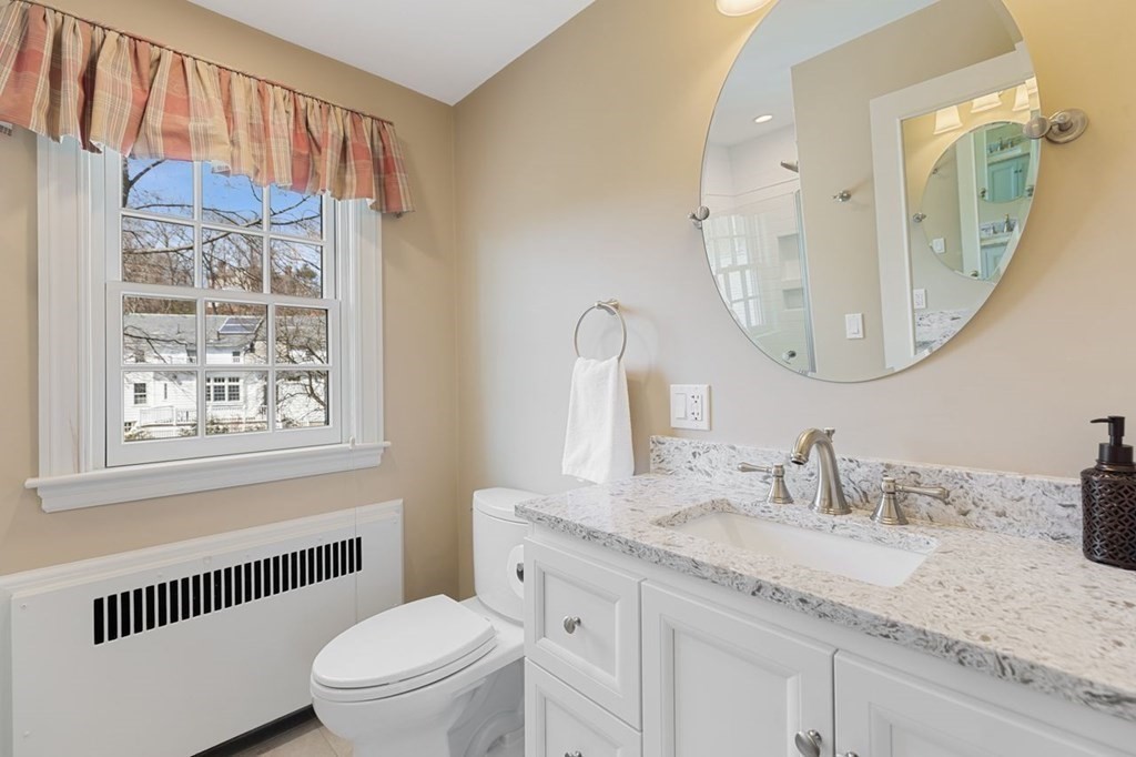 15 Gould Road Newton, MA 02468 - Photo 28 of 33 a bathroom with a granite countertop sink mirror vanity and toilet