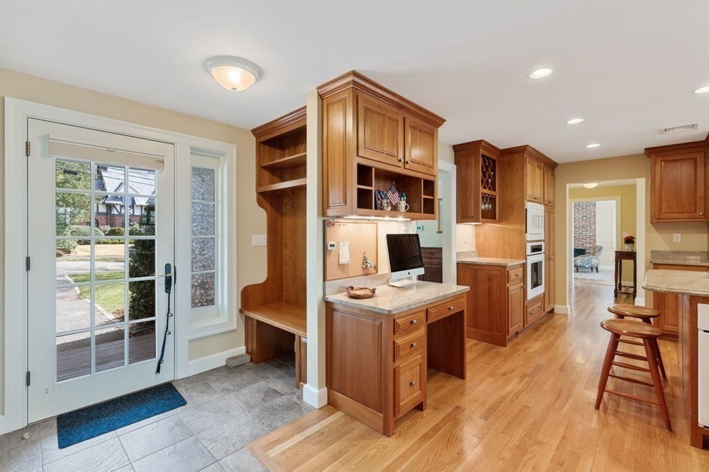 15 Gould Road Newton, MA 02468 - Photo 9 of 33 a view of a kitchen with kitchen island stainless steel appliances wooden floor and living room view