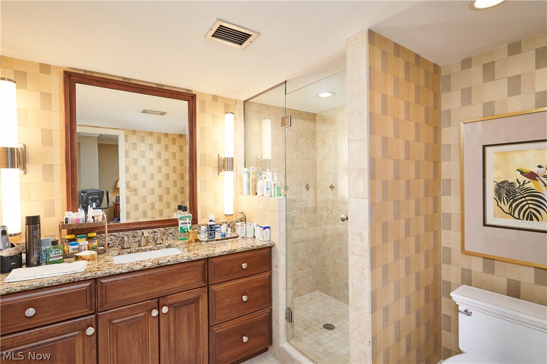 2385 Covington Road, Unit 304 Fairlawn, OH 44313 - Photo 16 of 21 Bathroom featuring vanity, a stall shower, wallpapered walls, and recessed lighting