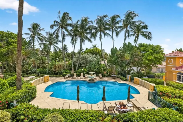 a blue and white umbrella sitting in front of a house