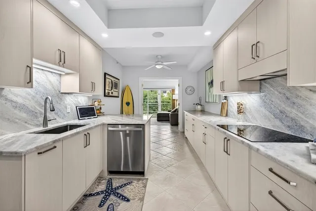 a kitchen with stainless steel appliances granite countertop a sink and cabinets