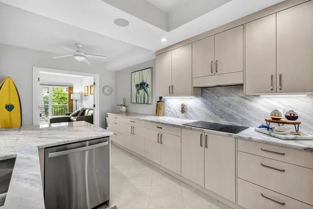 a kitchen with granite countertop cabinets stainless steel appliances a sink and a window