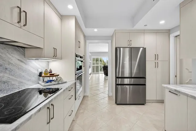a kitchen with stainless steel appliances a refrigerator a sink a stove and cabinets