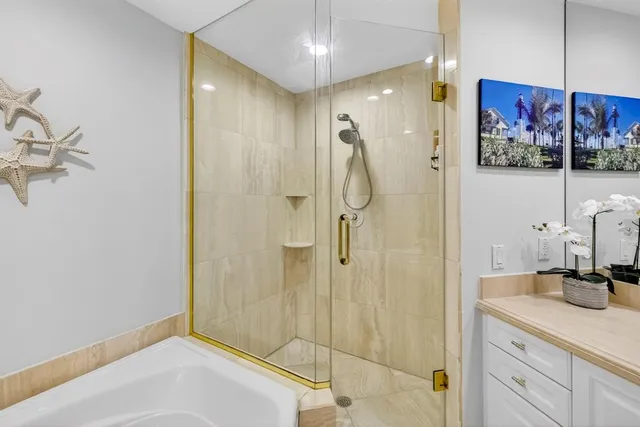 a bathroom with a tub sink and mirror