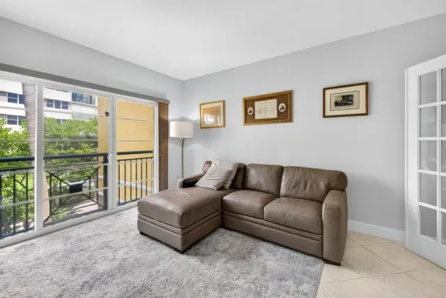 a living room with furniture cabinets and a flat screen tv